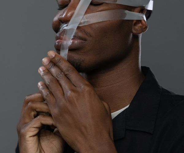 Close-up of a person's hands in a meditative gesture.